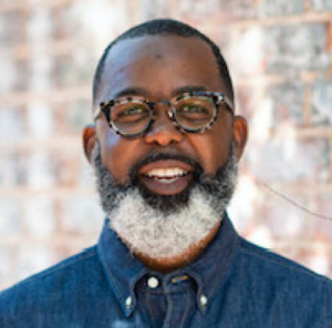 A person with a beard and glasses.